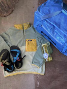 picture of paptagonia bag & fleece, chacos, water bottle,